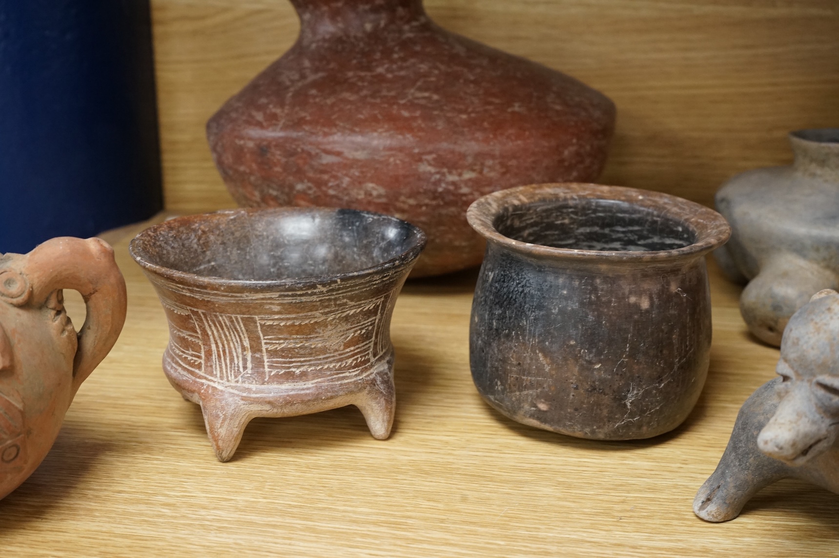 A collection of various South American vessels some in the form of grotesque heads, largest 24cm wide